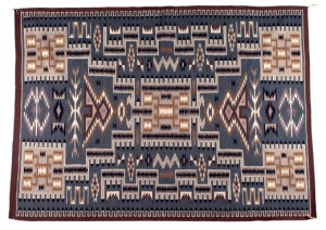 A Two Grey Hills interpretation of the Storm pattern, consisting of a central rectangle with four lines extending from its corners to four rectangles at the corners of the weaving, has been a popular Navaho design since the early 1900s. Image courtesy Cowan’s Auctions Inc.