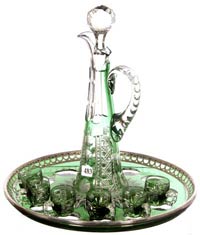 Eight-piece liqueur set, with emerald green cut to clear Montrose pattern decanter, six matching cordial cups and service tray ($8,500).