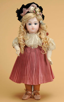 Circa-1880 Thullier (France) A.T. bébé with pale pressed-bisque socket head incised A.7T., light blue paperweight eyes, finely painted brows and lashes with mauve eye shadow, closed mouth, pierced ears and long-tailed blonde mohair wig with cork pate. Straight-wrist French composition and wood body, antique pink wool dress, ivory satin and lace blouse, antique velvet hat and matching shoes. 18 inches tall. Estimate: $45,000-$55,000.