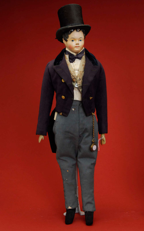 All-original circa-1850 papier-mâché man, finely molded with brush-painted wispy hair, molded and painted features, cloth body and wood arms. Stands 23 inches tall, wears original wool three-piece suit with silk brocade vest and white muslin blouse, accessorized with pocket watch and beaverskin top hat. Provenance states the doll belonged to the family of Israel Matson, a Revolutionary War soldier. Estimate: $2,000-$3,000.