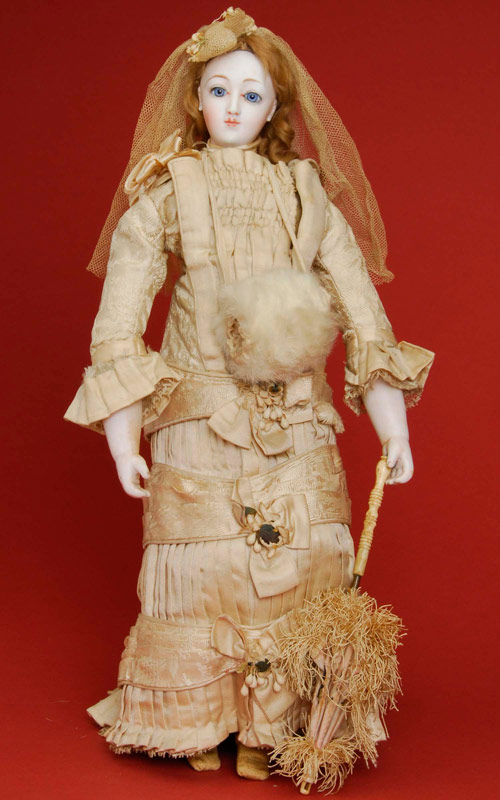 Circa-1875 all-original French portrait-face fashion lady with pressed-pale bisque flange head on bisque shoulder plate. Unusual portrait face modeling on a fine-quality fashion body, kid-over-wood jointed legs and finely modeled bisque lower arms. Stands 17 inches tall, wears original ivory embossed-silk walking dress with matching parasol. Estimate: $12,000-$15,000. 