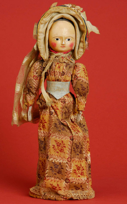 Circa-1750 English Queen Anne doll, 16 inches tall, all original, with carved wood head and torso, jointed legs and painted gesso head, shoulders and hands. Provenance: Estelle Winthrop Collection. Estimate: $10,000-$12,000.  