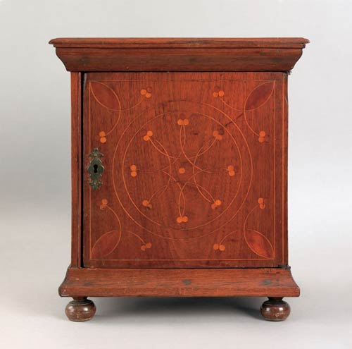Fine Chester County walnut spice box, 18th c., with compass star inlaid door enclosing nine small drawers, resting on turned ball feet, 15h, 12w.(case). $50,000-80,000.