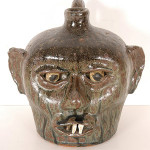 Face jug with china plate teeth, made in the 1960s by renowned potter Lanier Meaders (est. $4,000-$6,000). Image courtesy Slotin Folk Art.