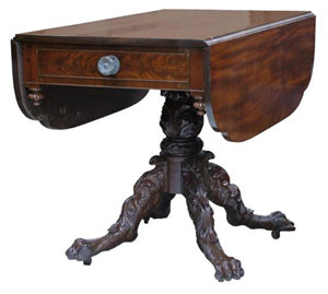 The hairy paw foot is an integral part of the ambiance of this Empire drop-leaf table.