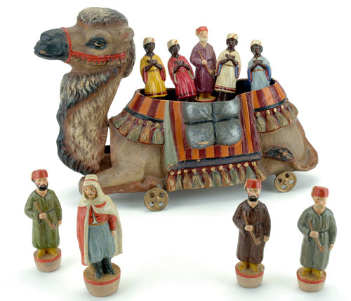 This finely modeled and painted papier-mâché and wood camel on wheels is not only a pull toy and nodder, but also houses a skittles set of figural ninepins. Noel Barrett auctioned the only other known example for $33,000 in 2006. Noel Barrett Auctions image.
