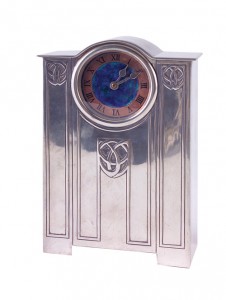 A fine and unusual example of a Tudric pewter closed-case clock designed by Archibald Knox with an embossed Celtic knot design and a clock face enameled in blue, green and copper. Image courtesy of Rago Arts and Auction Center, Lambertville, N.J.
