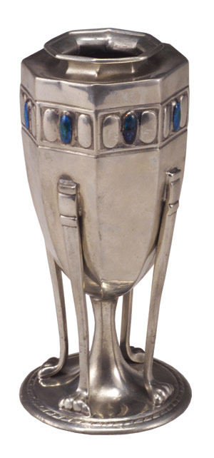 A fine Tudric pewter faceted vase with embossed band of ovals, some enameled in blue and green, with claw-feet supports. Images courtesy of Rago Arts and Auction Center, Lambertville, N.J.