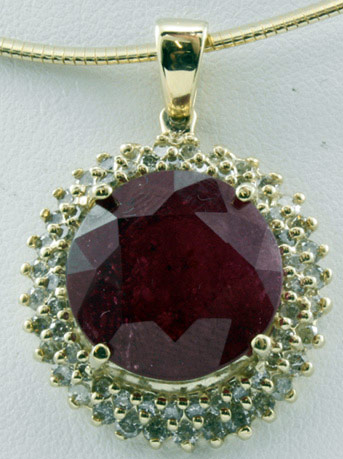 Ladies 14K yellow gold pendant mounted with a genuine ruby center stone hi-lighted by genuine diamond approx. 20 ctw ruby / 2.04 ctw diamond / 14.45 grams total weight  Estimate $50,254 - $75,382. Image courtesy Abercrombie Auctions International.