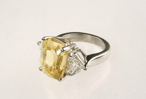 Platinum lady's ring set with 14.05 ct natural yellow sapphire flanked by two diamonds. Image courtesy Thomaston Place.