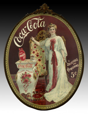Coca-Cola collectors put a premium on early advertising items like this 1904 cardboard cameo sign under glass. Complete with original brass frame, hanging chain and embossed crest at top, this sign measuring 8 1/2 by 11 1/2 inches sold for $5,500 in February 2007. Image courtesy Morphy Auctions and LiveAuctioneers.com Archive.