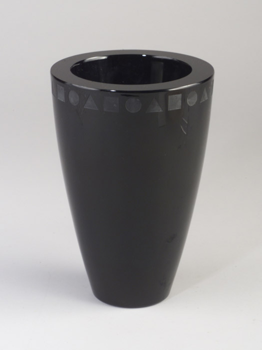 One of Ward Bennett's designs for Sasaki, a thick-walled black glass vase, its rim etched with circles, squares, and triangles. John Sollo says 'the market for 20th-century design has expanded to encompass even more recent designs, like the later work of Ward Bennett.' Image courtesy of Sollo Rago Modern Auctions.