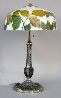 An obverse painted shade crowns this 19 1/2-inch table lamp. Image courtesy Pook & Pook.
