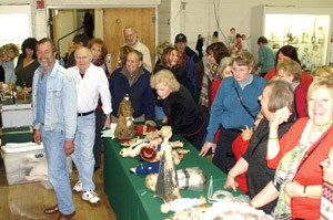 Those who attended the Mar. 7-8 Eastern National Antique Doll Show say the legacy of Richard Wright was evident. Wright, who died on Mar. 1, is shown at left (in denim jacket) at his busy booth at a past Gaithersburg show. Image courtesy Antique Doll Collector magazine.