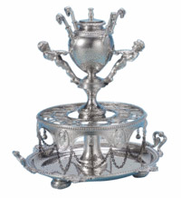 Cigars stood in the holes in the center of this sterling silver cigar accessory. The urn at the top is a lighter. The piece was made by Edward Moore for Tiffany & Co. and sold for $13,750 at a Sotheby's auction in New York. 