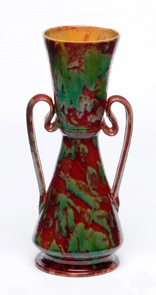 Red and green vase with handles, c. 1898, glazed ceramic, 7 3/4in x 5 1/4in. Collection of the Ohr-O’Keefe Museum of Art. Gift of Susan and Roland Samson.