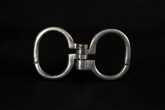Nickel-plated folding handcuffs known as 'Hamburg 8's' that were owned and used by Harry Houdini. Estimate $3,000-$4,000. Image courtesy LiveAuctioneers.com/Potter & Potter.