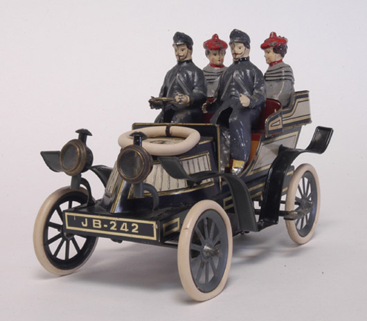 An extremely rare German production by Gunthermann, this clockwork open phaeton with four hand-painted passenger figures features glass-fronted headlamps and a white rubber spare wheel on a curved bonnet. It sold to a phone bidder for $62,100 against an estimate of $20,000-$25,000. Image courtesy Bertoia Auctions.