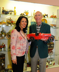 'I was very pleased that our campaign to reach the fine art community attracted the interest of many in the trade who do not ordinarily buy toys but who now have an interest,' said Jeanne Bertoia, shown here with dealer Peter Tillou of Litchfield, Conn., with a handsome Alfa-Romeo racer he purchased at the sale. Photo by Phil Dutton, courtesy Bertoia Auctions.