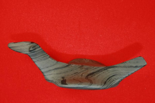 Banded-slate birdstone, 4 inches, found on McKechron Fram north of Alveston, Ontario, Canada. Estimate $2,000-$6,000. Courtesy Old Barn Auction.