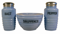 This Delphite kitchen set was made to keep on the kitchen stove. The large drippings jar held grease. The set was offered online at DepressionKitchenGlass.com for $245.