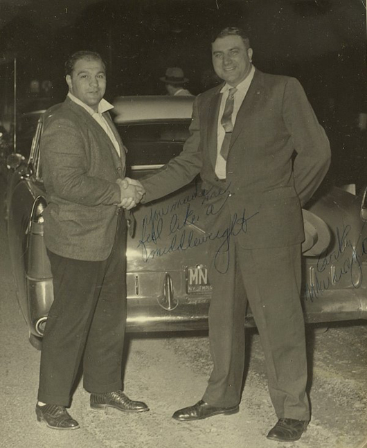 Heavyweight champion Rocky Marciano, left, signed this photograph for a much bigger New York state trooper while in training in the Catskills. The 8-by-10 photo has a $1,200-$2,000 estimate. Image courtesy Written Word Autographs.