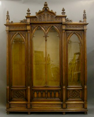 Made by Mercier Freres, Paris, this late 19th-century Gothic Revival walnut breakfront bookcase has adjustable shelving and its original finish. It carries a $4,000-$8,000 estimate. Image courtesy Schmidt's Antiques.