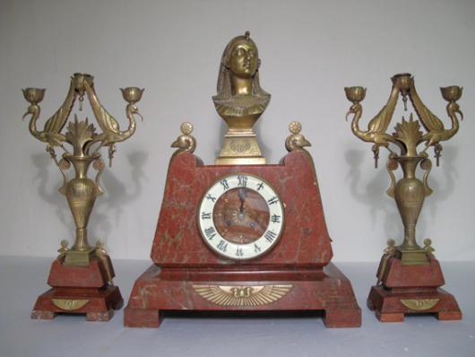 Red marble complements the Egyptian Revival motif of this French clock and garniture candelabra. The set has a $1,500-$2,500 estimate. Image courtesy Neapolitan Auctions. 