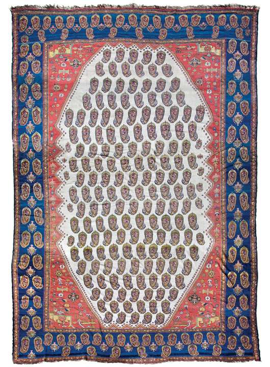 Senneh rug having wide border with navy reserve with interspersed boteh and flowering urns throughout, the interior with a deep orange field around the central diamond form field with ivory reserve with boteh, or paisley, pattern throughout in multiple colors. Approximately 22 feet 3 inches x 13 feet 2 inches. Estimate $10,000 to $15,000. Image courtesy Leslie Hindman Auctioneers.