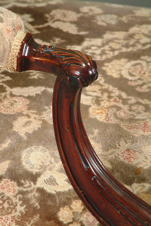 Fig. 3 - A detail of the carved armrest on the George III carved mahogany ‘Gainsborough' armchair that topped Dreweatts' July 15 sale.