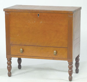 Typically the top of a 19th-century sugar chest opens on hinges to reveal an interior divided with a board front to back. Image courtesy Cowan's.