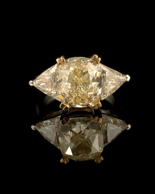 An 18-karat white and yellow gold setting secures a natural light yellow cushion-cut diamond weighting 7.01 carats, which is flanked on either side by a white trillion-cut diamond weighting 1.0 carat each. The stunning lady's ring is estimated at $60,000-$90,000. Image courtesy New Orleans Auction Galleries.
