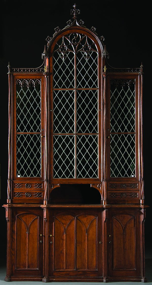 Standing more than 10 feet tall is a fine German or Flemish 19th-century carved oak Gothic Revival cabinet with green leaded glass in the doors. It has a $1,000-$2,000 estimate. Image courtesy Jackson's.