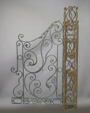 The scrolling ironwork on this Mediterranean-style garden gate and column are typical of the work done by custom ironworkers. The gate is 86 inches high and 58 inches wide. Image courtesy New Orleans Auction and Live Auctioneers archive.