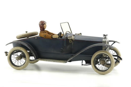 Bignan (Nain Bleu, France) boat-tail tinplate luxury auto, 18 inches long, clockwork driven with spoke wheels, mounted spare and numerous quality details. Estimate $10,000-$12,000.