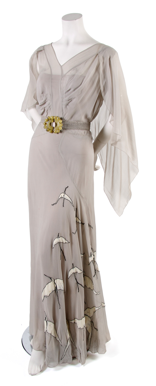 French couture pale blue day dress, probably 1920s, bias cut with bird appliques along skirt, attached belt with Art Deco-style clasp, low back, matching slip. Estimate $200-$400. Courtesy Leslie Hindman Auctioneers.