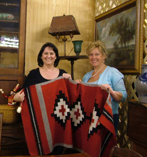 Jo Valentine (left) and auctioneer Cynthia Schillig, partners in The Antiques Auction Gallery, a new business in Sunbury, Ohio.