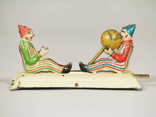 Clowns tossing a ball, one of 20 tinplate penny toys in the sale, estimate $700-$1,000. Image courtesy RSL Auction.