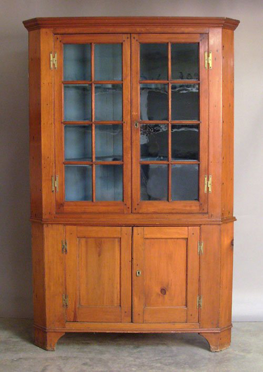 Constructed in two parts makes this Pennsylvania pine corner cupboard easier to handle. The 78-inch-tall cupboard has an $800-$1,200 estimate. Image courtesy Pook and Pook Inc.