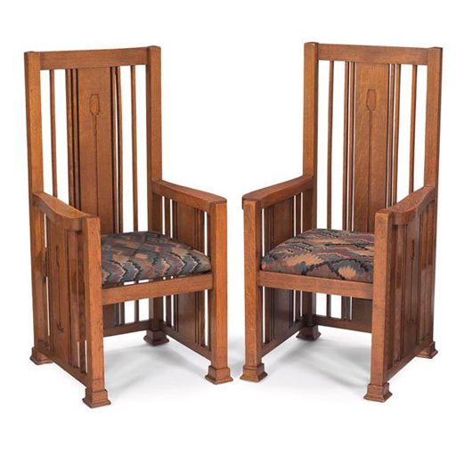 These armchairs are part of a Prairie School dining set produced around 1910, possibly by George M. Neidecken. The set also includes a trapezoidal china cabinet, a rectangular table on a platform base and four six matching side chairs. The estimate is $20,000-$30,000. Image courtesy Treadway Toomey Galleries.
