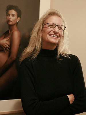 Photographer Annie Leibovitz alongside her photographic portrait of Demi Moore that appeared on the cover of Vanity Fair magazine. This photo was shot by Marc Silber of www.silberstudios.com. Sourced through Wikimedia Commons.