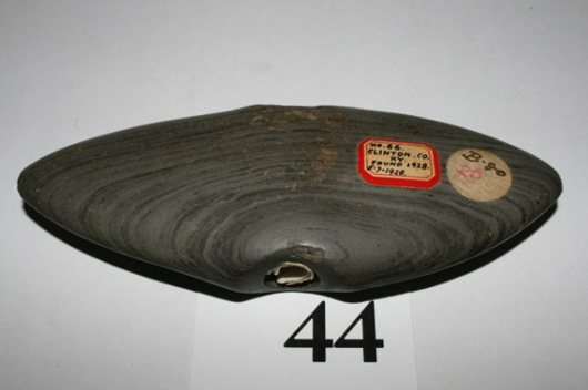The old label on this banded slate winged bannerstone indicates it was discovered July 7, 1928 in Clinton County, Ky. Image courtesy Old Barn Auction.