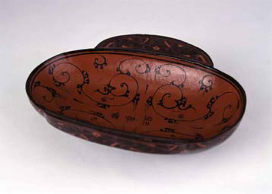 A cloud pattern and inscriptions ‘Jun Xing Jiu' and ‘Si Sheng,' are found on this lacquer flanged cup. Image courtesy Hunan Provincial Museum.