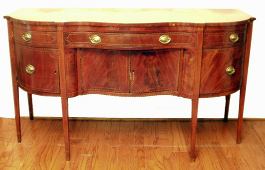 Some inlay and veneer loss is noted on this American Federal serpentine sideboard, which was crafted in New York state circa 1800. It measures 40 inches high, 72 inches long and 29 1/2 inches deep. Image courtesy Richard Opfer Auctioneering Inc.