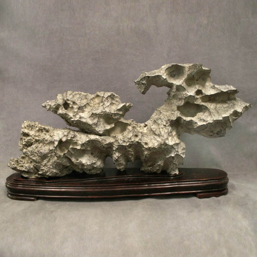This Chinese limbi stone scholar's rock with stand is 20 inches high by 38 inches in length. It has an $8,000-$12,000 estimate. Image courtesy William Jenack Auctioneers.