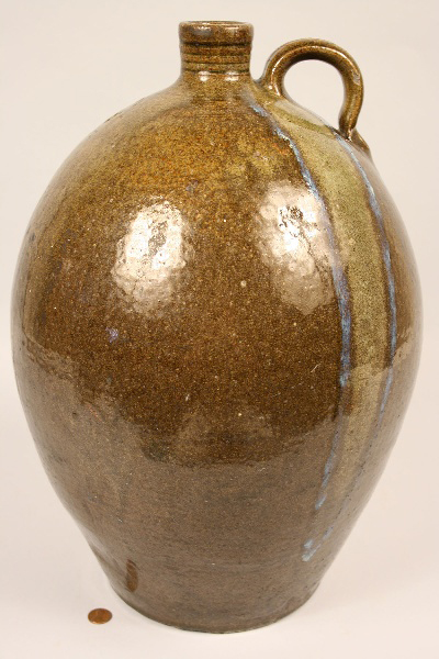 An alkaline glazed jug with glass rutile drip, stamped 