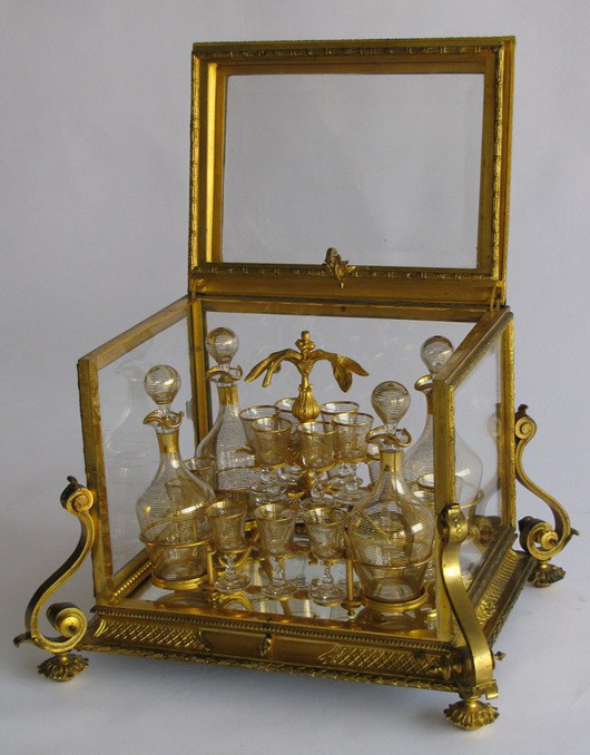 The class and bronze case of this Louis XV-style tantalus set measures 13 by 18 by 15 inches. Image courtesy Great Gatsby's Antiques & Auctions.