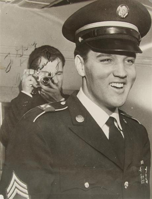 An autographed 8- by-10-inch photo of Elvis Presley when he served in the U.S. Army has a $1,500-$2,500 estimate. Image courtesy of Leslie Hindman Auctioneers.