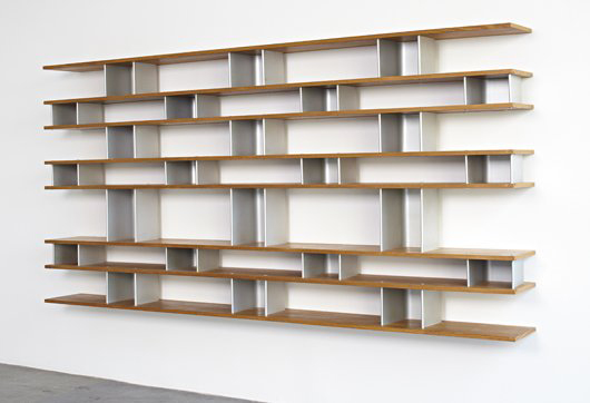 Charlotte Perriand designed this wall-mounted bookcase circa 1950. Constructed of oak and aluminum, the shelf unit is 26 1/2 feet wide by 11 1/2 feet high. It has a $127,000-$190,000 estimate. Image courtesy of Phillips de Pury & Co.