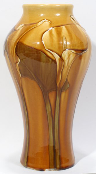 Large calla lilies decorate the exterior of this 11 3/4-inch Rookwood Pottery vase signed by Matthew Daly. It has a $2,000-$4,000 estimate. Image courtesy DuMouchelles.